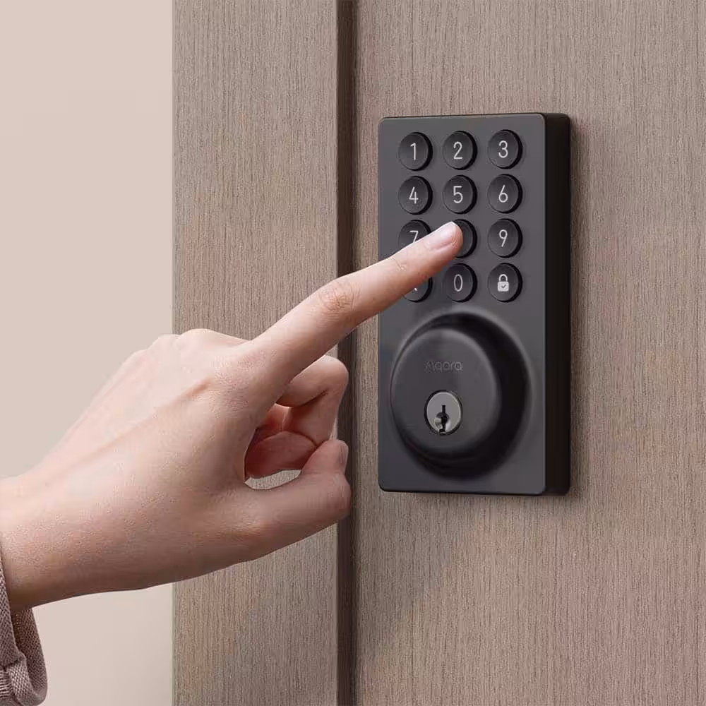 Aqara Smart Door Lock B50 — with Installation 10 Aqara Smart Lock B50 installed on a wood door with a finger pressing the keypad to unlock