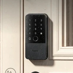 Aqara Smart Rim Lock U500 mounted on a front door in the rain, showing its weatherproof design